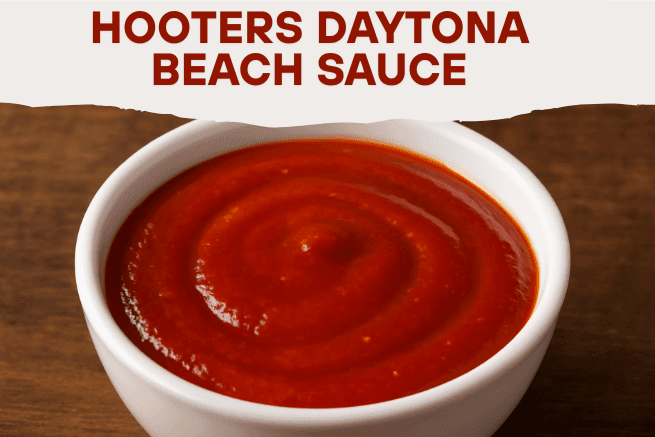 A bowl of thick, red sauce labeled "Hooters Daytona Beach Sauce" in bold red text at the top, with the bowl placed on a dark wooden surface. The sauce appears smooth and glossy with a swirled surface.
