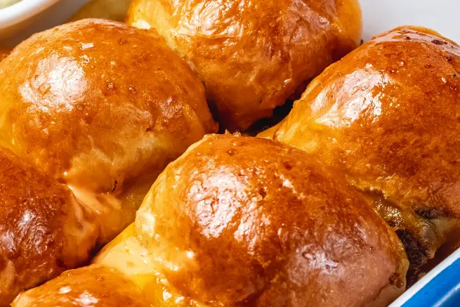 Golden Corral rolls served with crispy fries and coleslaw, featuring soft, golden buns with melted cheese and savory filling, ideal for comfort food lovers.