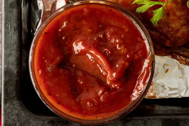 Top view of thick, homemade Wendy's BBQ sauce in a glass bowl.