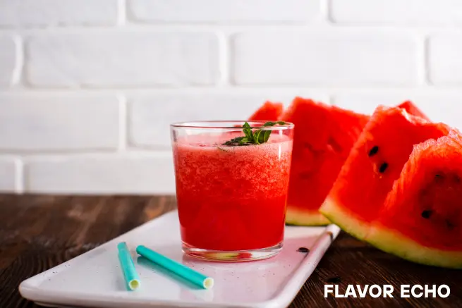 Watermelon shot on a tray with fresh fruit slices and two straws, labeled 'Flavor Echo' on a rustic wooden surface