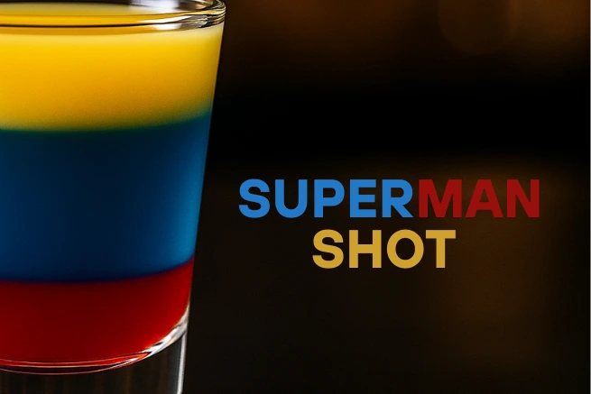 Close-up of a Superman Shot cocktail with vivid red, blue, and yellow layers, set against a dark background with bold “SUPERMAN SHOT” text.

